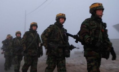 South Korean marines patrol Yeonpyeong Island after the country fired shells into waters claimed by both Koreas.