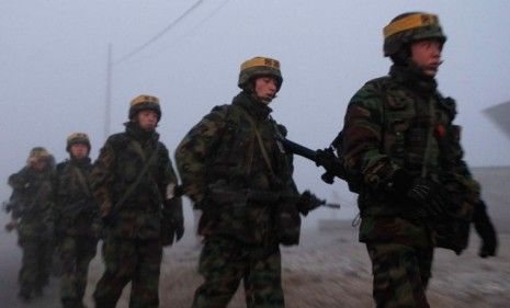 South Korean marines patrol Yeonpyeong Island after the country fired shells into waters claimed by both Koreas.