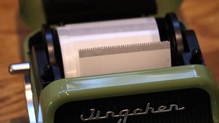 Niimbot B21 review; a small green label printer with its paper holder open