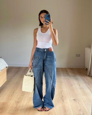 Die Influencerin trägt Jeans mit gebogenen Nähten.