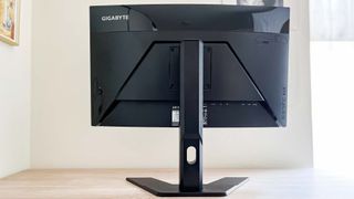Gigabyte G27FC review unit on a desk, port array facing camera