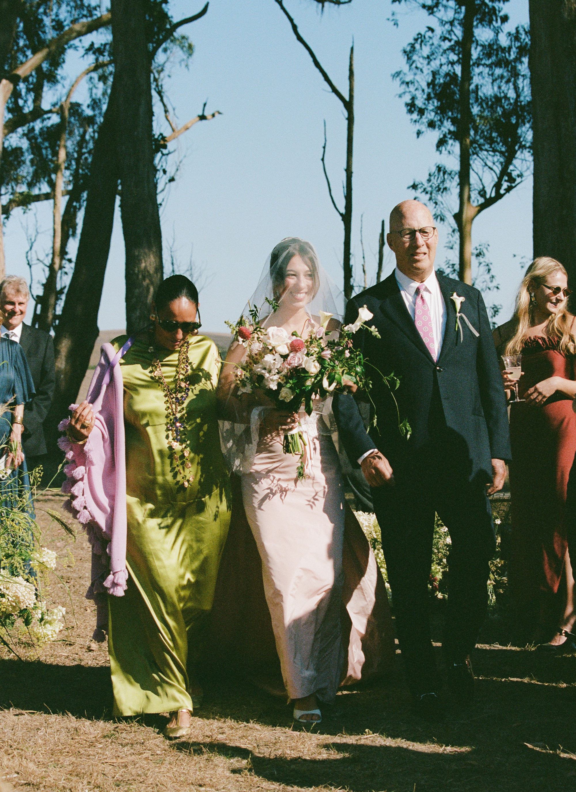 Hadley with her parents walking down the aisle.
