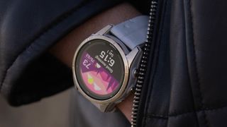 Garmin Fenix 7 Pro smartwatch on wrist with hand in coat pocket