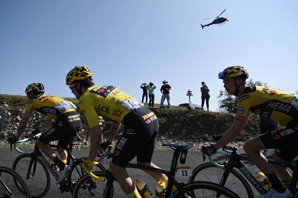 Team Jumbo rider Slovenias Primoz Roglic C wearing the overall leaders yellow jersey climbs Col de la Biche during the 15th stage of the 107th edition of the Tour de France cycling race 175 km between Lyon and Grand Colombier on September 13 2020 Photo by Marco BERTORELLO AFP Photo by MARCO BERTORELLOAFP via Getty Images