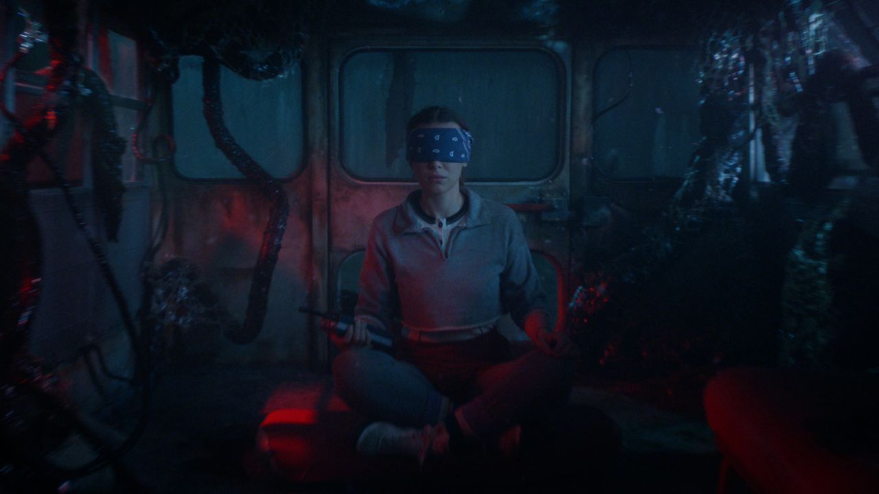 Eleven (Millie bobby Brown) meditates in a van in the Upside Down in "Stranger Things" season 5