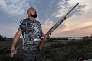 A Maltese hunter stands proud, having legally shot a European Turtle Dove