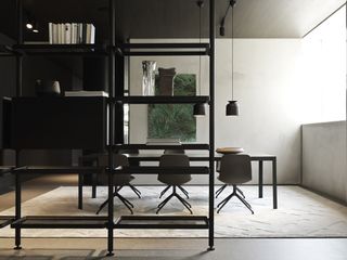 The first floor dining room, with Michael Anastassiades' Half a Square table and Barbican chairs by Rodolfo Dordoni. Vincent Van Duysen's new Hector bookshelf divides the space from the nearby living area, while on the opposite wall is an artwork by Brazilian artist Pietro Pasolini