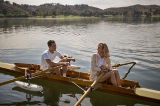 Lessons in Chemistry cast Lewis Pullman as Calvin Evans and Brie Larson as Elizabeth Zott in a rowing boat. 