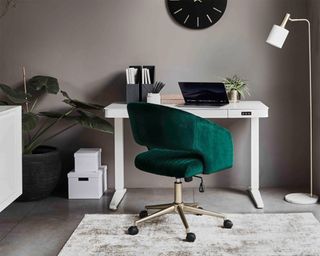 Adjustable desk with green velvet chair by Furniture Village
