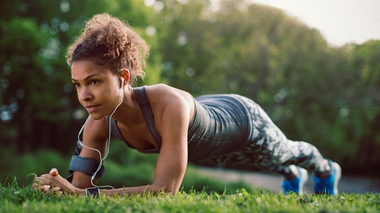 Woman performs core workout outside