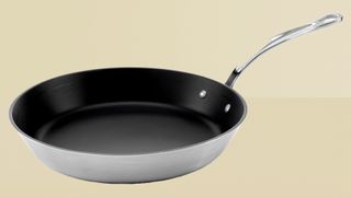 Samuel Groves Tri-Ply Stainless Steel Non-Stick frying pan on yellow background