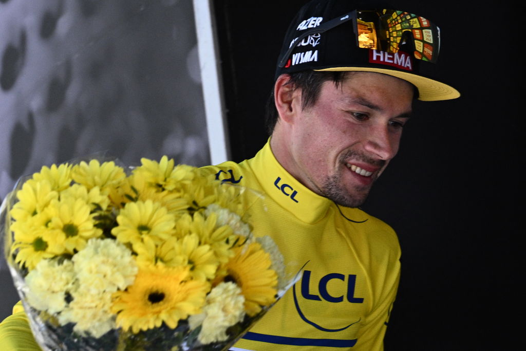 JumboVisma teams Slovenian rider Primoz Roglic wears the overall leader yellow jersey as he leaves the podium after the seventh stage of the 74th edition of the Criterium du Dauphine cycling race 135kms between SaintChaffrey to Vaujany southeastern France on June 11 2022 Photo by Marco BERTORELLO AFP Photo by MARCO BERTORELLOAFP via Getty Images