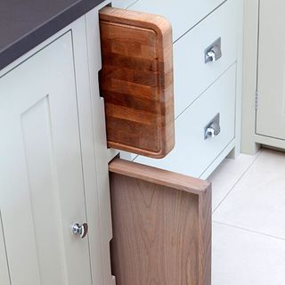 kitchen storage with wooden chopping board and cupboard