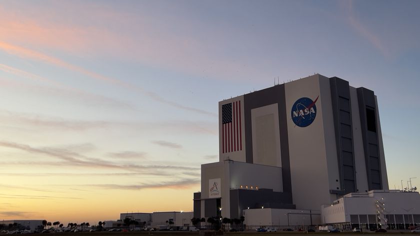 A building with the NASA logo. There is a sunset and pinkish clouds.