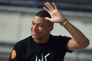 Liverpool target Kylian Mbappe waves to PSG supporters during "Les rencontres inspirantes" (inspiring meetings) organised by his association "Inspired by KM" at The Arena of Nimes, southern France, on October 12, 2022.