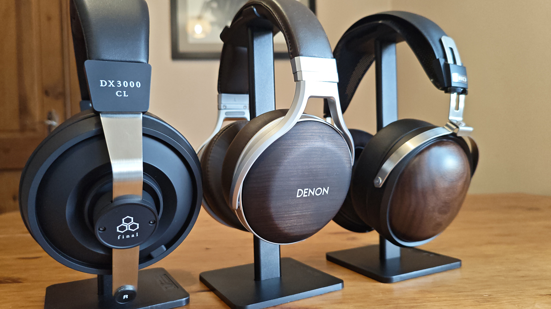 The Denon AH-D5200 and other headphones, photographed on a home desktop. 