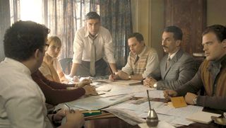 The characters of Operation Finale, one of the best Netflix war movies, at a table