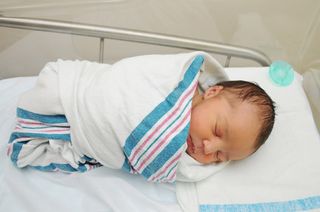 newborn baby boy wrapped in blanket