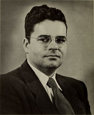 a man in a suit poses for a portrait