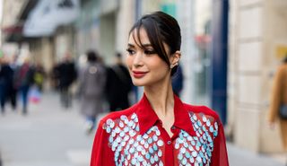 Heart Evangelista wears red sequined button up dress with slit outside Dries van Noten during the Womenswear Fall/Winter 2024/2025 as part of Paris Fashion Week on February 28, 2024 in Paris, France.