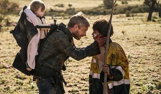 Cargo Martin Freeman talking with a child in the outback