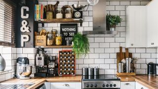 kitchen makeover with white metro tiles, wooden worktops and industrial open shelving