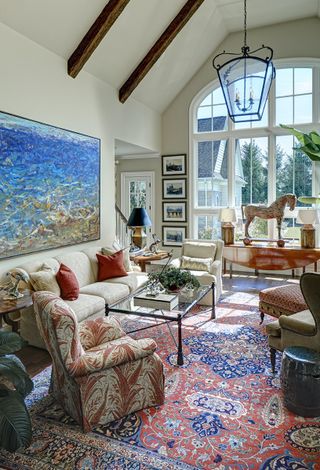 vaulted french style living room with antiques and persian rug