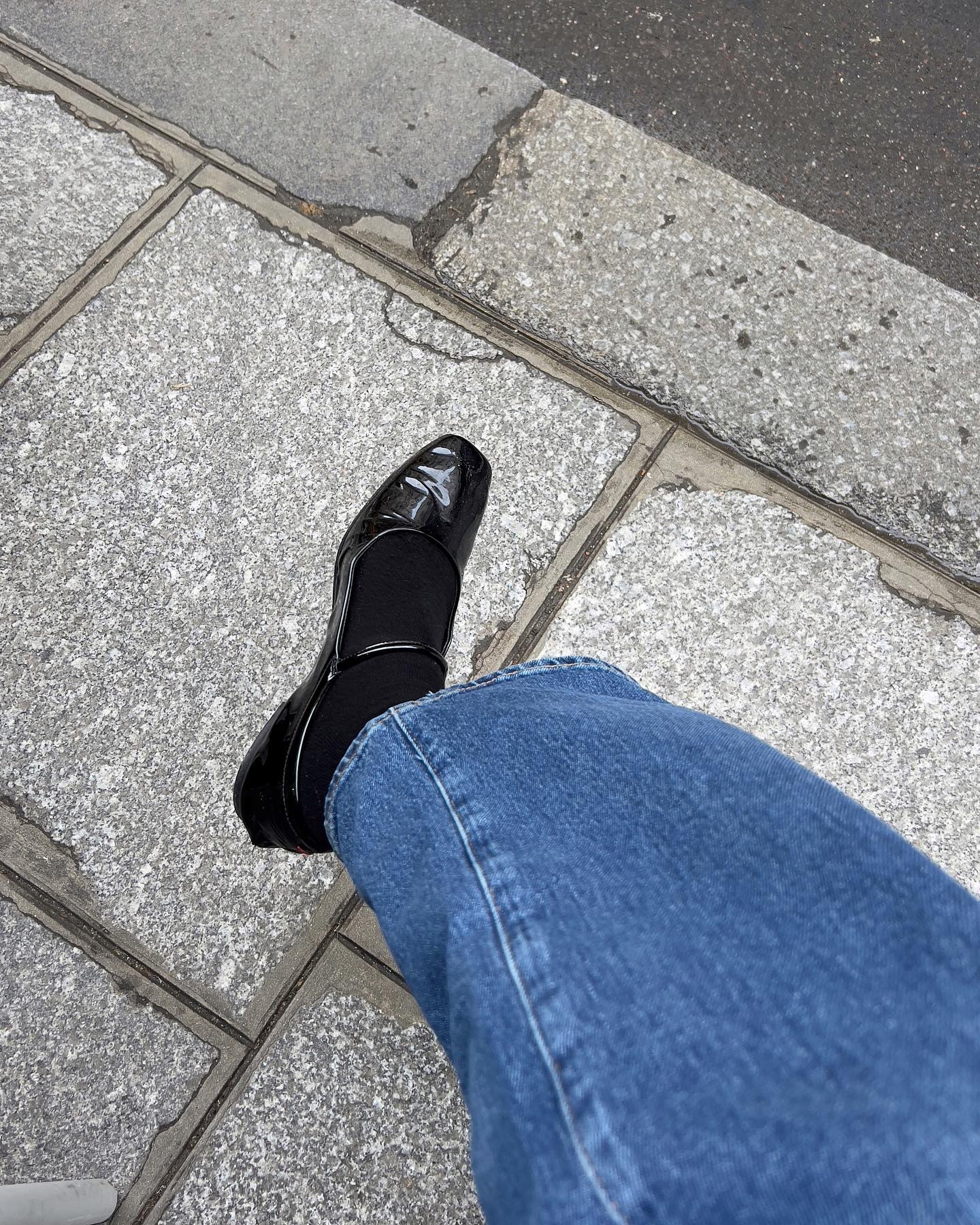 Jeans with black socks and patent leather Mary Janes.
