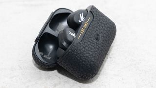 the marshall motif anc true wireless earbuds in their charging case