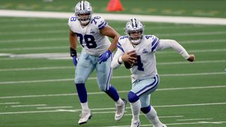 Dallas Cowboys quarterback Dak Prescott scrambles with the ball in hand