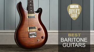 A PRS SE 277 baritone guitar leaning against a wall