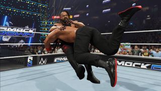 Promotional screenshot of Jacob Fatu getting speared by Roman Reigns in WWE 2K25