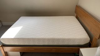 the Tempur Hybrid Elite Mattress shown on our reviewer's wooden bed frame