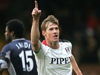 Brian McBride raises his arm in celebration after scoring for Fulham against Bolton Wanderers, 2005