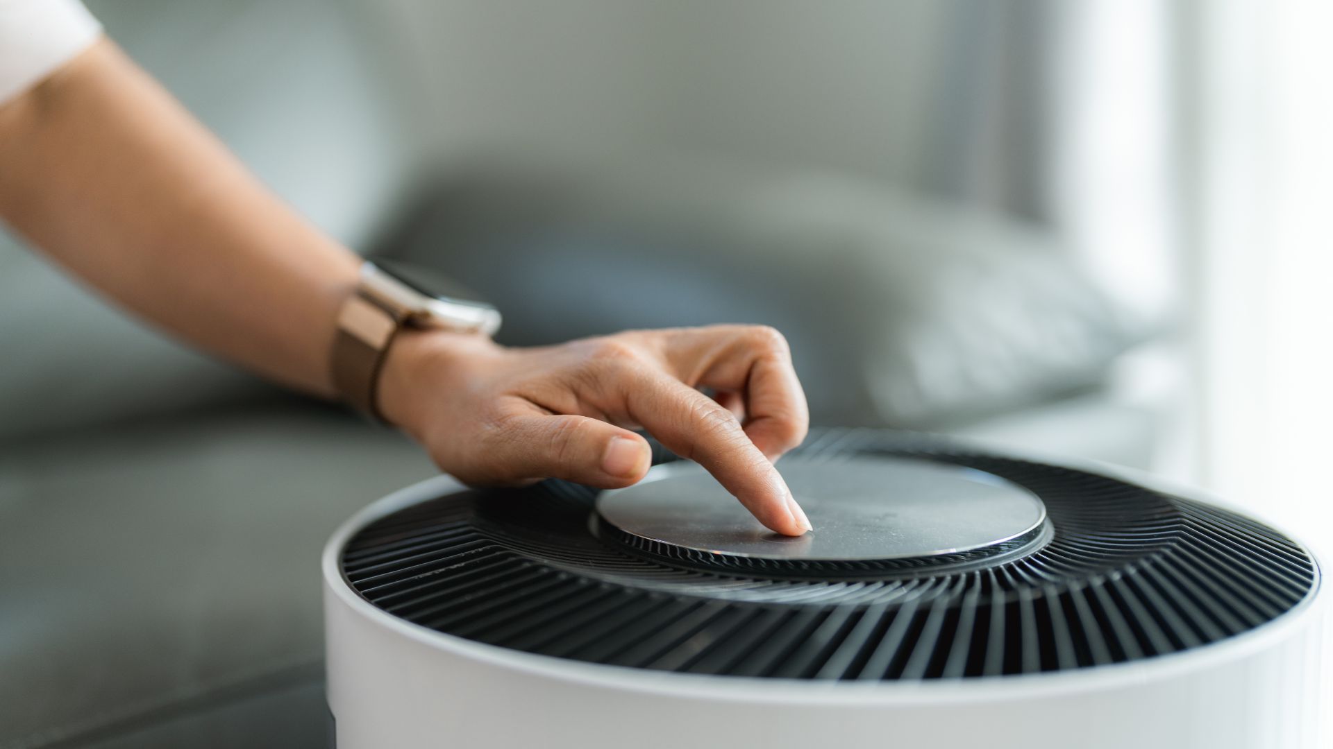 picture of woman turning on air purifier