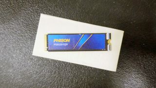 Phison E28 M.2 SSD, on a black and white background.