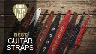 A selection of leather guitar straps in different colors on a wooden floor