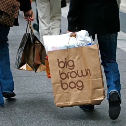 David Benjamin, left, carries shopping bags including a Gucci bag,and Paolo Presta, right, also carries shopping bags, including a "big brown bag" from Bloomingdale's as the two men stroll down Michigan Avenue, in Chicago, Illinois, Wednesday, December 8, 2006.