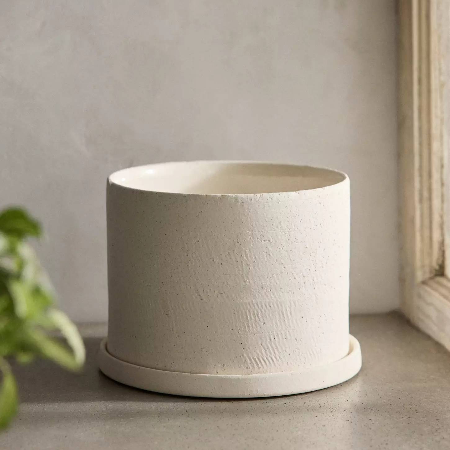 White ceramic planter and saucer