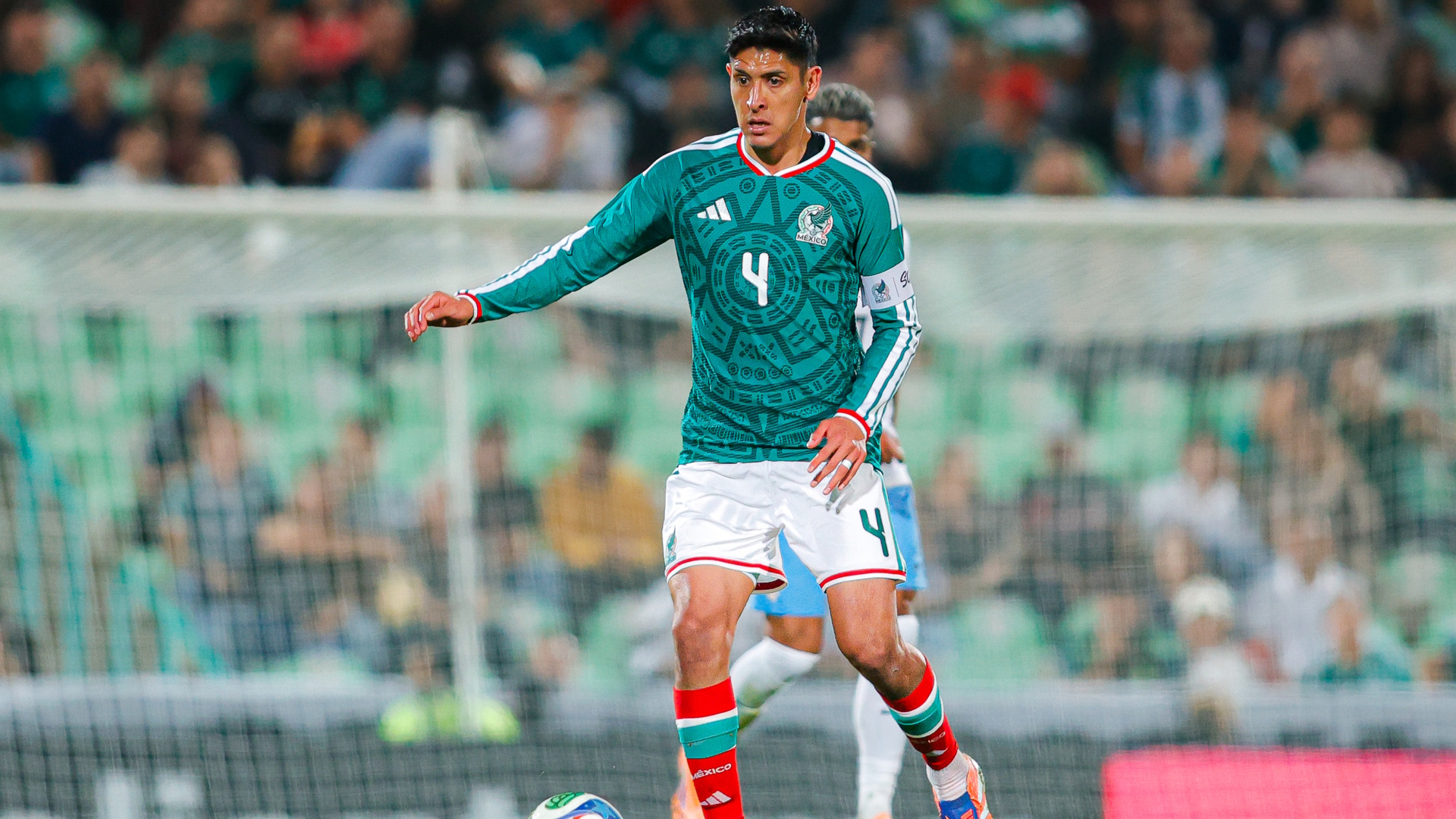 Edson Alvarez of Mexico dribbles the ball during an international soccer match.