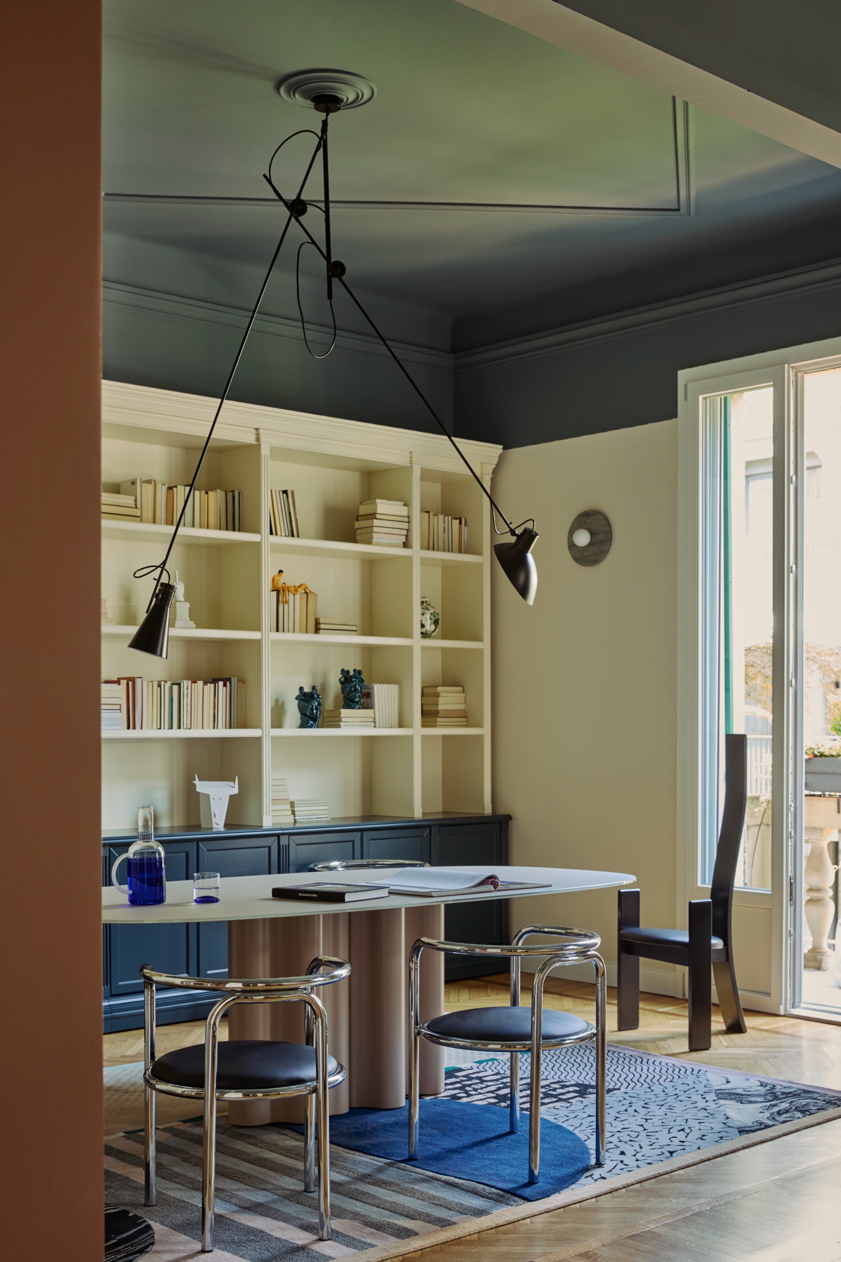 study with blue painted ceiling, modern chrome furniture, a blue rug, and large windows