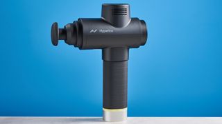 the hyperice hypervolt 2 pro massage gun with a long ergonomic handle and interchangeable massage head attachments