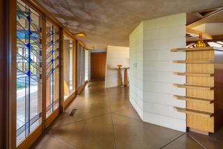 A large entryway with floor to ceiling windows