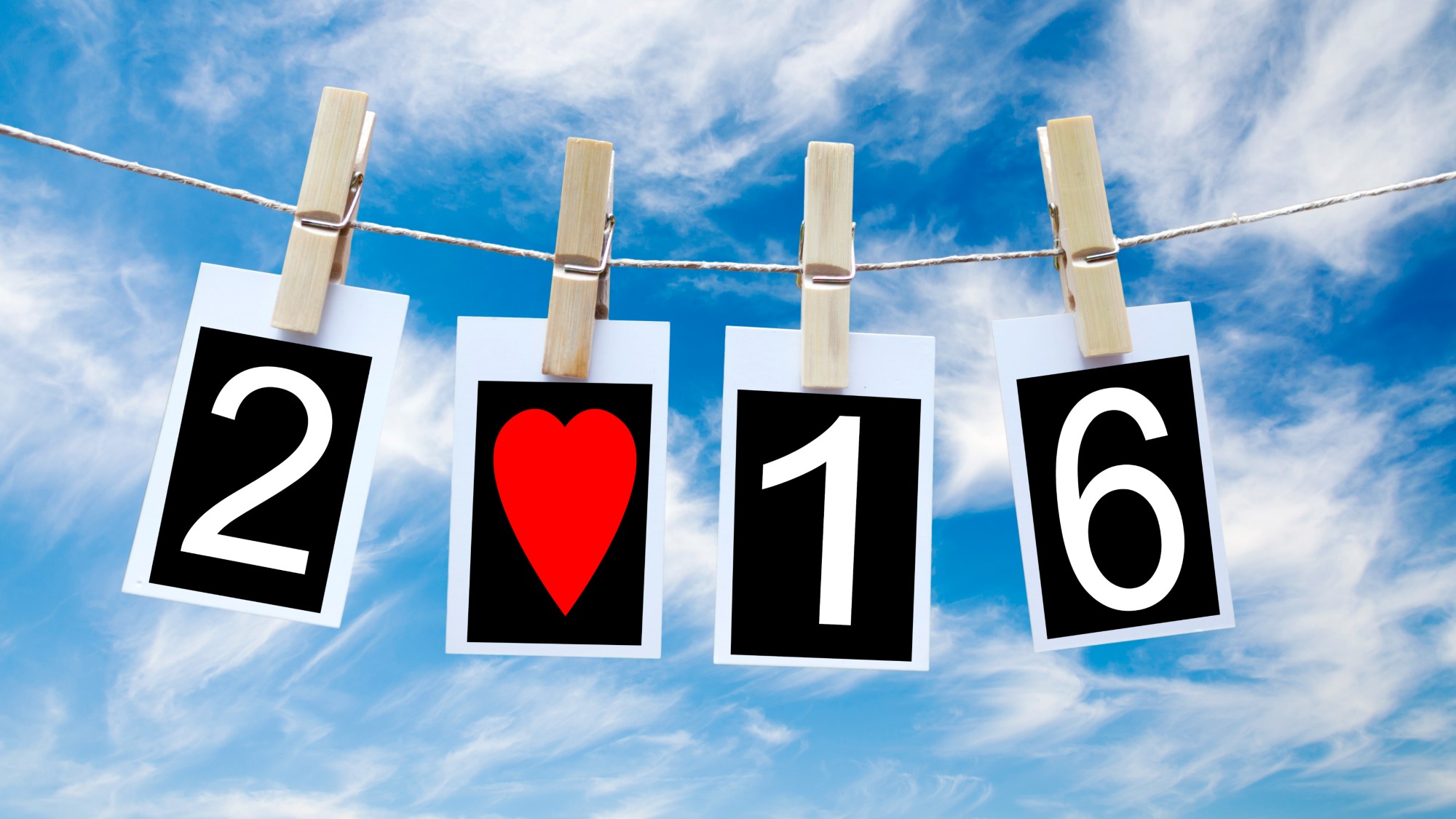 2016 over the cloudy sky on a clothesline with a red heart replacing the 0