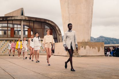 Picture of models walking in the Chanel Cruise 2025 runway show on roof of concrete Le Corbusier building in Marseille