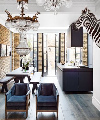 A quirky kitchen with brick walls and decadent furnishing