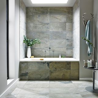 bathroom with alcove bathtub and skylight