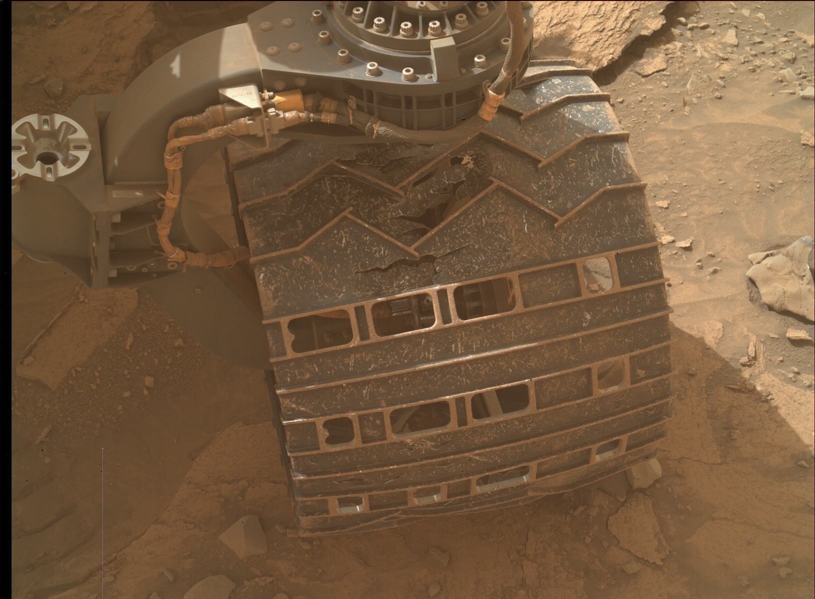 A wheel of the Mars Curiosity rover showing damage from rugged terrain