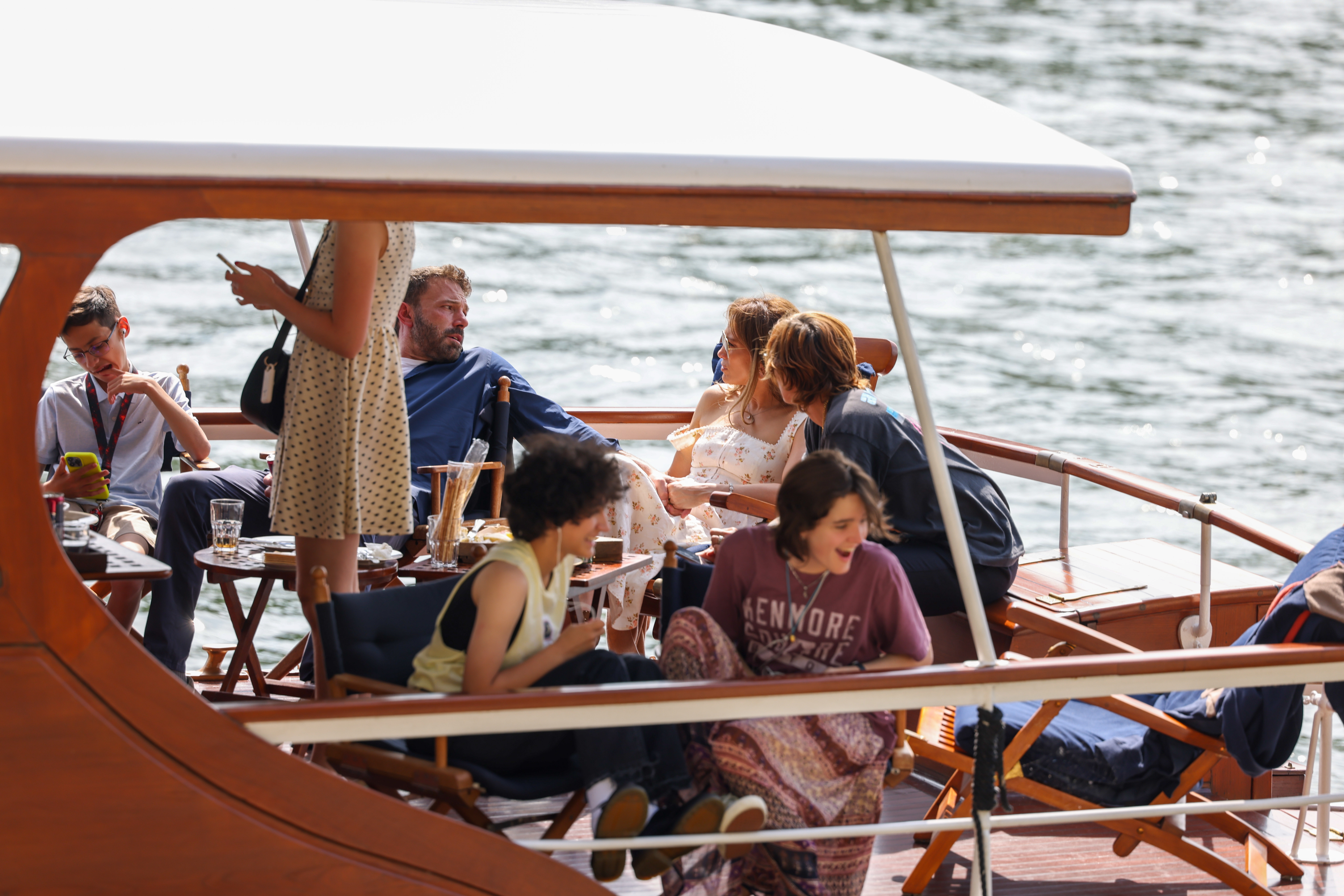 PARIS, FRANCE - JULY 23: Jennifer Lopez and Ben Affleck take a cruise on the River Seine along with some of their children, Seraphina Affleck (front R) and Emme Muniz (front L) on July 23, 2022 in Paris, France. (Photo by Pierre Suu/GC Images)