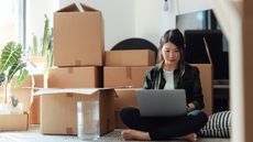 Woman sitting by boxes